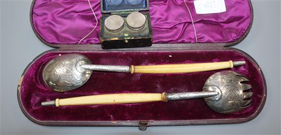 A pair of Victorian ivory handled silver salad servers by George Adams, London, 1859 and two silver annointing pots.